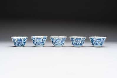 A set of 11 Chinese blue and white cups and saucers with riverscape design, Kangxi