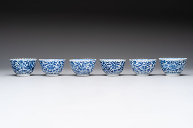 A set of six Chinese blue and white cups and saucers with floral design, Kangxi