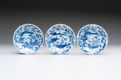 A set of 11 Chinese blue and white cups and saucers with riverscape design, Kangxi
