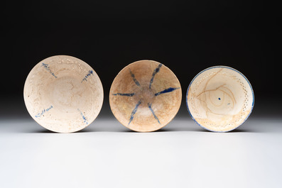 Three Kashan blue and white pierced pottery bowls, Iran, 12/13th C.