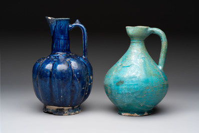 A Kashan turquoise-glazed ewer and a Nishapur blue-glazed ewer, Iran, 12th C.