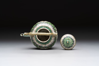 A Chinese verte biscuit teapot and cover with floral design, Kangxi