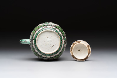 A Chinese verte biscuit teapot and cover with floral design, Kangxi