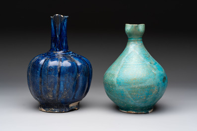 A Kashan turquoise-glazed ewer and a Nishapur blue-glazed ewer, Iran, 12th C.