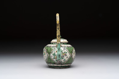 A Chinese verte biscuit teapot and cover with floral design, Kangxi
