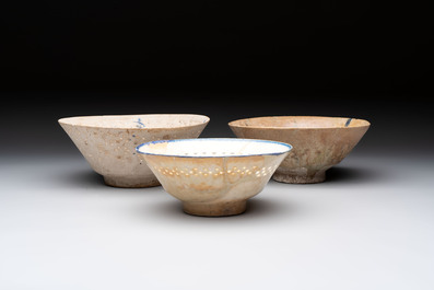 Three Kashan blue and white pierced pottery bowls, Iran, 12/13th C.