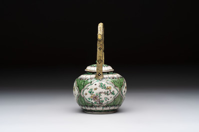 A Chinese verte biscuit teapot and cover with floral design, Kangxi