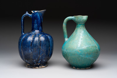 A Kashan turquoise-glazed ewer and a Nishapur blue-glazed ewer, Iran, 12th C.