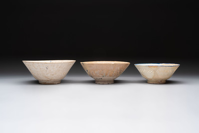 Three Kashan blue and white pierced pottery bowls, Iran, 12/13th C.