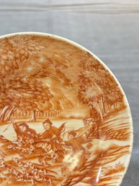 A Chinese iron-red-decorated 'Deer Hunting' cup and saucer, Qianlong
