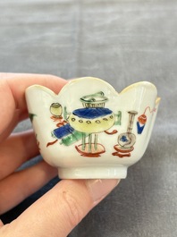 A pair of Chinese famille verte cups and saucers with antiquities, Kangxi