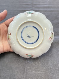 A pair of Chinese famille verte cups and saucers with antiquities, Kangxi