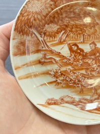 A Chinese iron-red-decorated 'Deer Hunting' cup and saucer, Qianlong