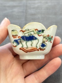 A pair of Chinese famille verte cups and saucers with antiquities, Kangxi