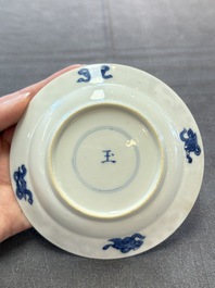 A Chinese blue and white 'Rotterdam Riot' cup and saucer, jade mark, Kangxi