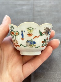 A pair of Chinese famille verte cups and saucers with antiquities, Kangxi