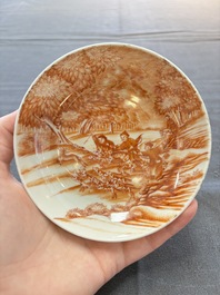 A Chinese iron-red-decorated 'Deer Hunting' cup and saucer, Qianlong