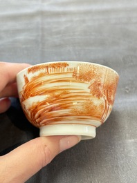 A Chinese iron-red-decorated 'Deer Hunting' cup and saucer, Qianlong