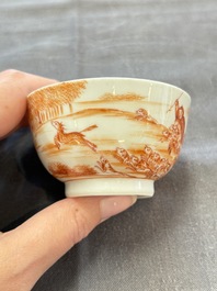 A Chinese iron-red-decorated 'Deer Hunting' cup and saucer, Qianlong