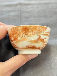 A Chinese iron-red-decorated 'Deer Hunting' cup and saucer, Qianlong
