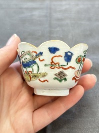 A pair of Chinese famille verte cups and saucers with antiquities, Kangxi