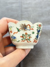 A pair of Chinese famille verte cups and saucers with antiquities, Kangxi