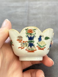 A pair of Chinese famille verte cups and saucers with antiquities, Kangxi