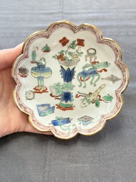 A pair of Chinese famille verte cups and saucers with antiquities, Kangxi