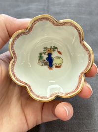 A pair of Chinese famille verte cups and saucers with antiquities, Kangxi