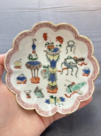 A pair of Chinese famille verte cups and saucers with antiquities, Kangxi