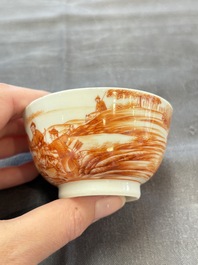 A Chinese iron-red-decorated 'Deer Hunting' cup and saucer, Qianlong