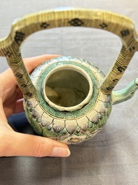 A Chinese verte biscuit teapot and cover with floral design, Kangxi