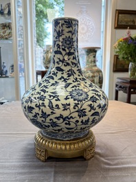A gilt-bronze-mounted Chinese blue and white bottle vase with floral design, 19/20th C.
