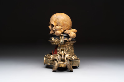 An Italian 'vanitas' or 'memento mori' skull with wooden crossbones on gilt-bronze base, 18/19th C.