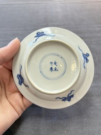 A pair of Chinese blue and white 'Elegant Beauty and Boy' cups and saucers, Chenghua mark, Kangxi