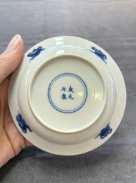 A pair of Chinese blue and white 'elegant beauty and boy' cups and saucers, Chenghua mark, Kangxi
