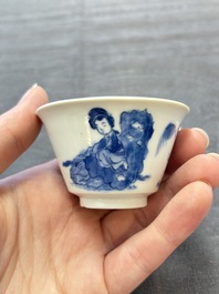 A pair of Chinese blue and white 'Elegant Beauty and Boy' cups and saucers, Chenghua mark, Kangxi