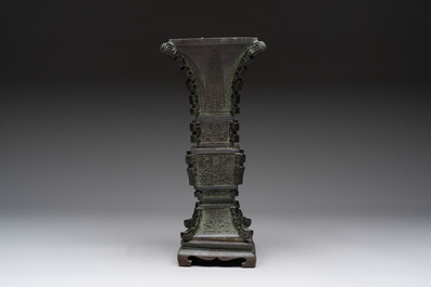 A Chinese archaistic bronze 'gu' vase and stand, Qing