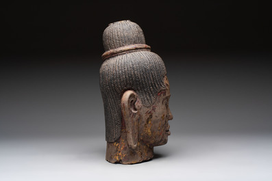 A Cambodian stone head of Shiva with braided hair and traces of gilt lacquer, Khmer Baphuon-style, 20th C.