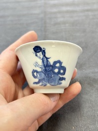 A pair of Chinese blue and white 'Elegant Beauty and Boy' cups and saucers, Chenghua mark, Kangxi
