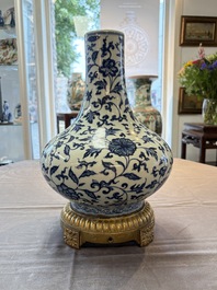 A gilt-bronze-mounted Chinese blue and white bottle vase with floral design, 19/20th C.