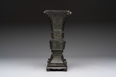 A Chinese archaistic bronze 'gu' vase and stand, Qing