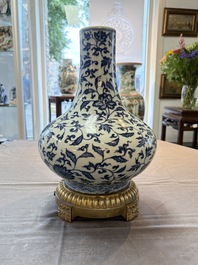 A gilt-bronze-mounted Chinese blue and white bottle vase with floral design, 19/20th C.