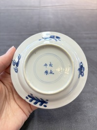A pair of Chinese blue and white 'elegant beauty and boy' cups and saucers, Chenghua mark, Kangxi