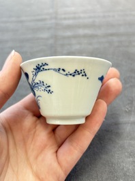 A pair of Chinese blue and white 'elegant beauty and boy' cups and saucers, Chenghua mark, Kangxi