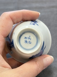 A pair of Chinese blue and white 'elegant beauty and boy' cups and saucers, Chenghua mark, Kangxi