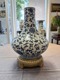A gilt-bronze-mounted Chinese blue and white bottle vase with floral design, 19/20th C.
