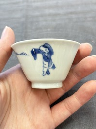A pair of Chinese blue and white 'elegant beauty and boy' cups and saucers, Chenghua mark, Kangxi
