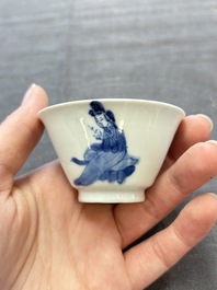 A pair of Chinese blue and white 'elegant beauty and boy' cups and saucers, Chenghua mark, Kangxi