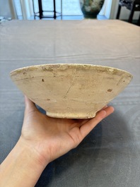 A Samanid pottery 'Kufic' inscribed bowl and a white-spotted brown-ground bowl, Iran, 10th C.